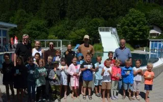 Kinder und Betreuer im Freibad Zell am Ziller mit Rutsche und Becken