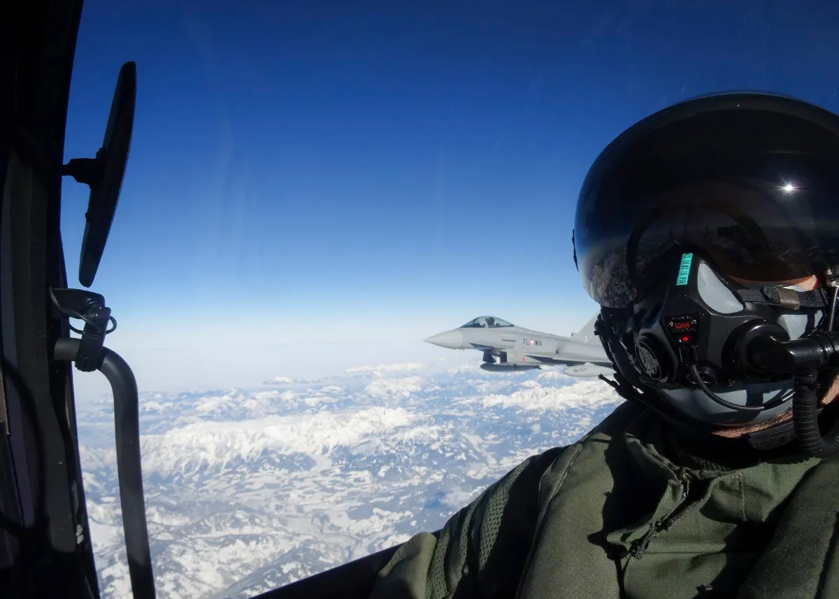 Eurofighter Typhoon fliegt über schneebedeckten Alpen, Pilotenperspektive