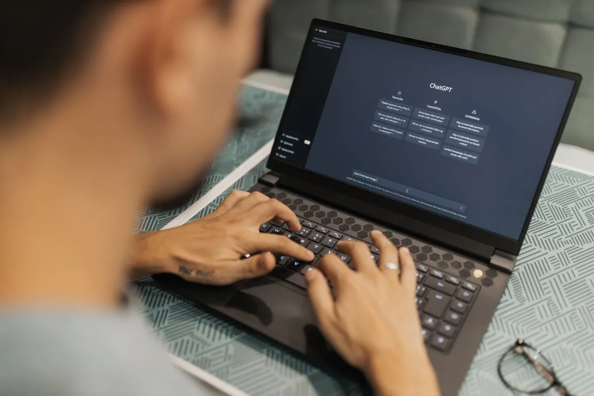 ChatGPT: Mann tippt Frage auf Laptop in Wien, Österreich