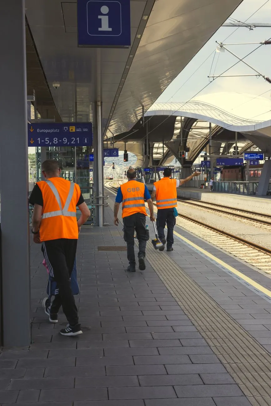 ÖBB-Mitarbeiter in Warnwesten auf Bahnsteig in Wien Meidling